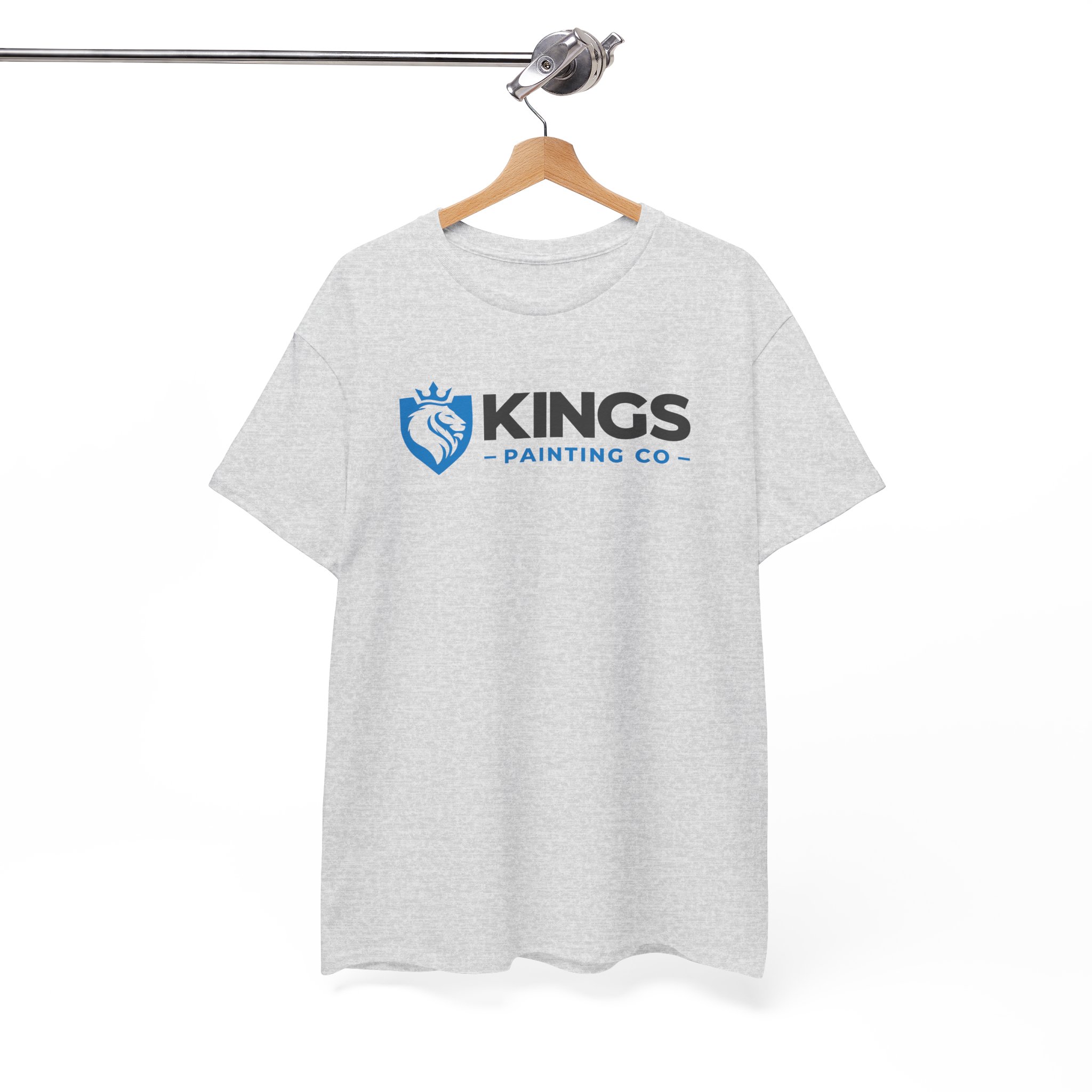 A Kings Painting Co. Logo T‑Shirt | Gildan Ultra Cotton (G2000) in light gray hangs on a wooden hanger from a metal clothing rack, showcasing the blue shield and lion logo on the front against a white background.