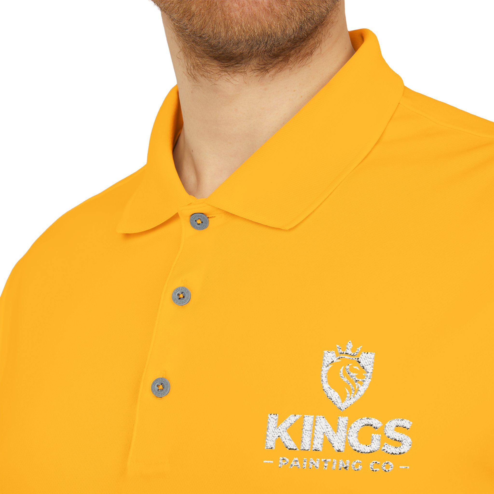 A man is wearing the Kings Painting Co. Performance Polo by Under Armour®, featuring a bright yellow color and a white embroidered KINGS PAINTING CO with crown logo on the left chest. Only his lower face, neck, and upper torso are visible.