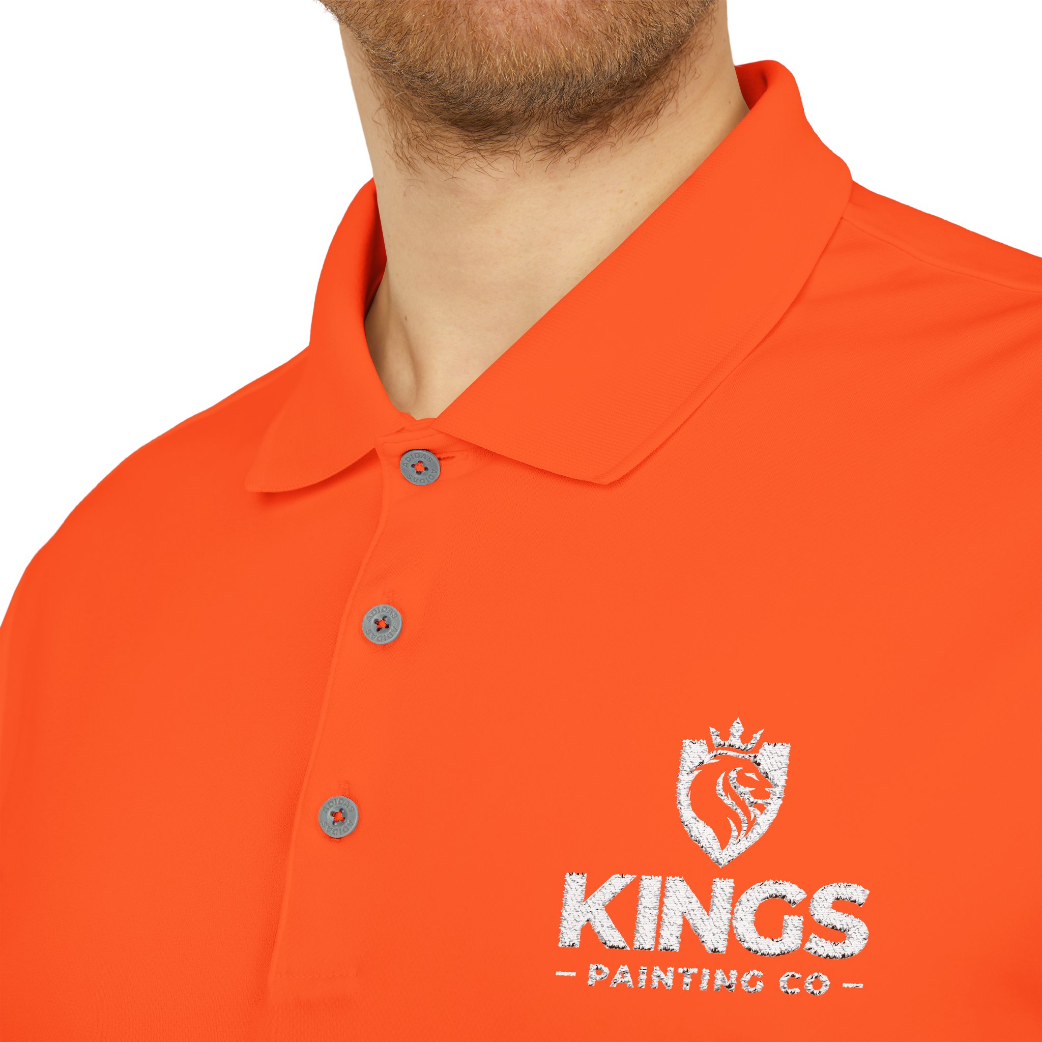A person wearing the Kings Painting Co. Performance Polo by Under Armour®, featuring a white logo and "KINGS PAINTING CO" text on an orange collared shirt. Only their lower face, neck, and upper torso are visible.