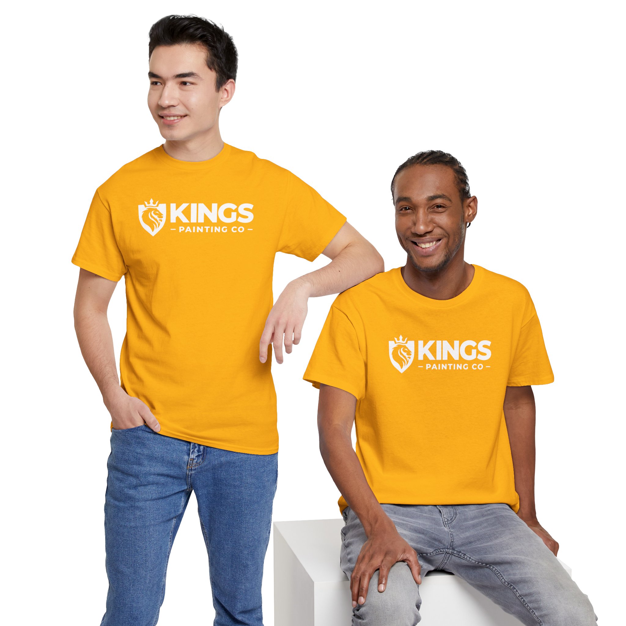 Two men, both smiling and dressed in matching bright yellow Kings Painting Co. Logo T‑Shirts (Classic) | Gildan Ultra Cotton (G5000), with one standing and the other sitting on a white block against a plain white background.