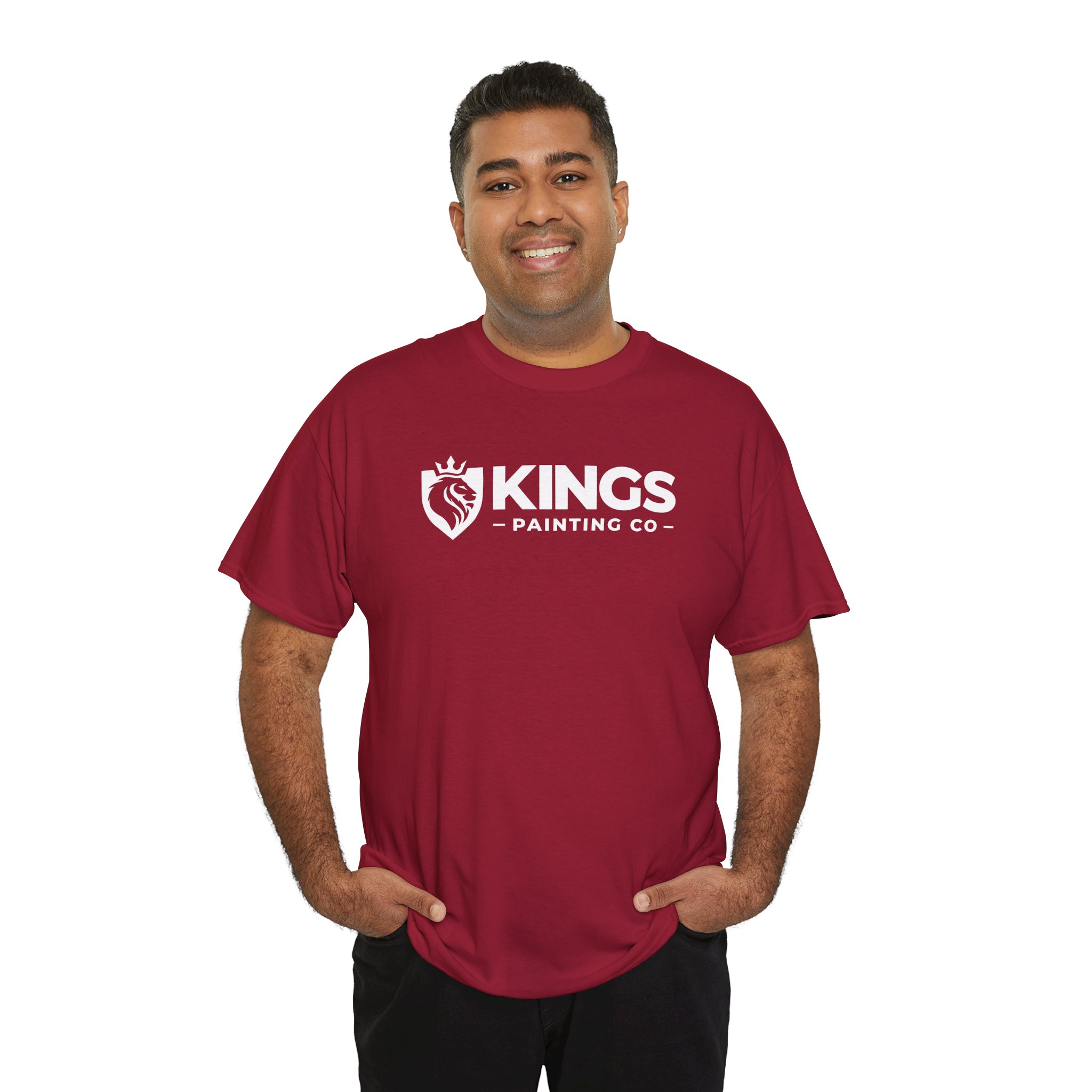 A smiling man stands with his hands in his pockets against a plain white background, wearing the Kings Painting Co. Logo T‑Shirt (Classic) in red—printed on a Gildan Ultra Cotton (G5000).